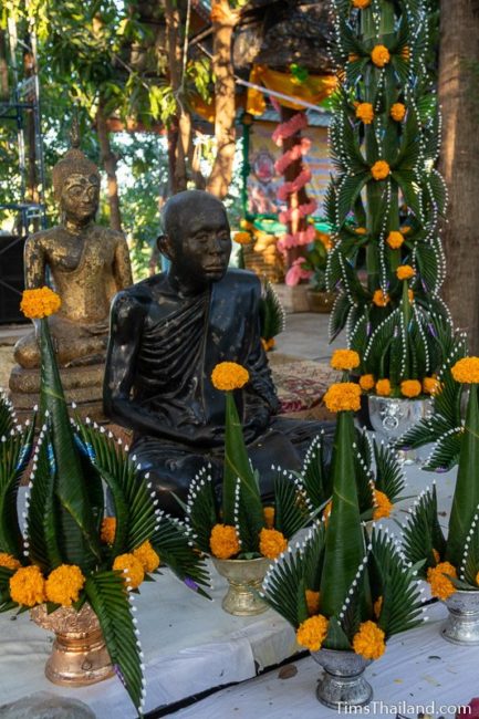 monk statue surrounded by bai sii