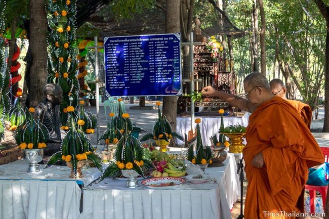 monk splashing water around monk statue