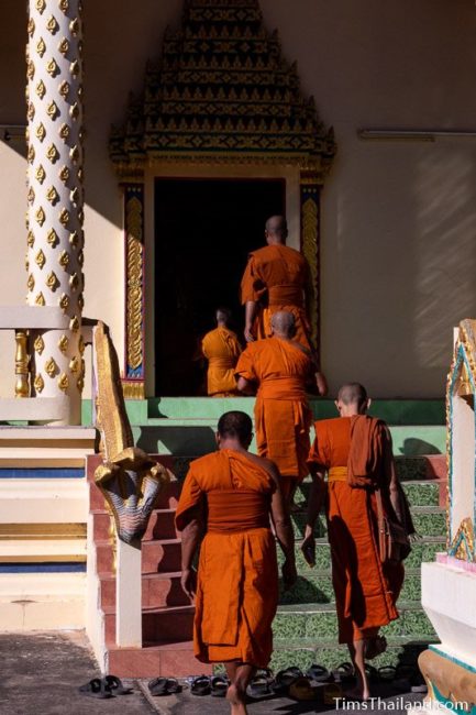 monks walking into the ubosot
