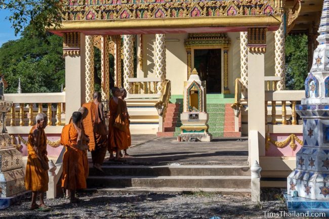 monks waiting in front of the ubosot