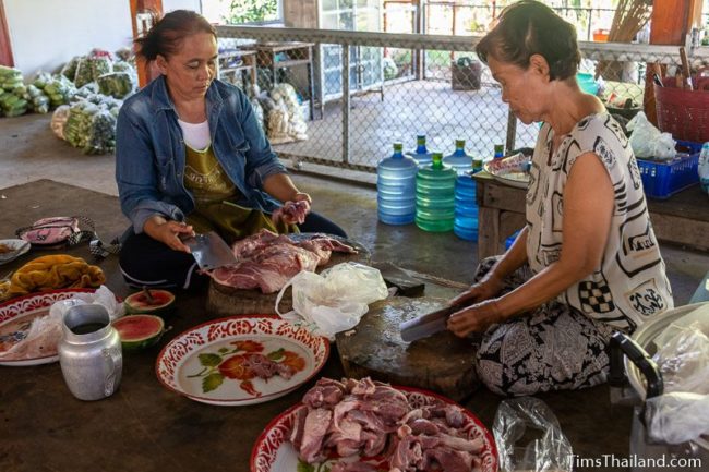 women cutting meat