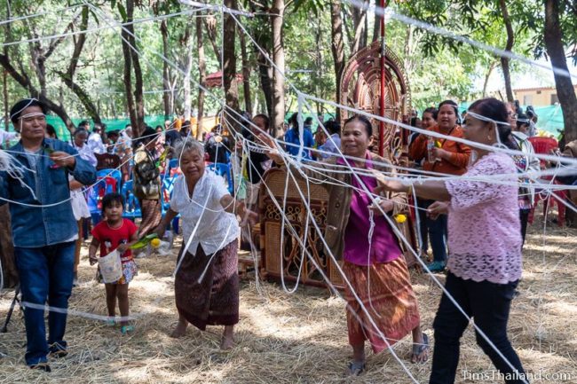 people cutting down the string grid