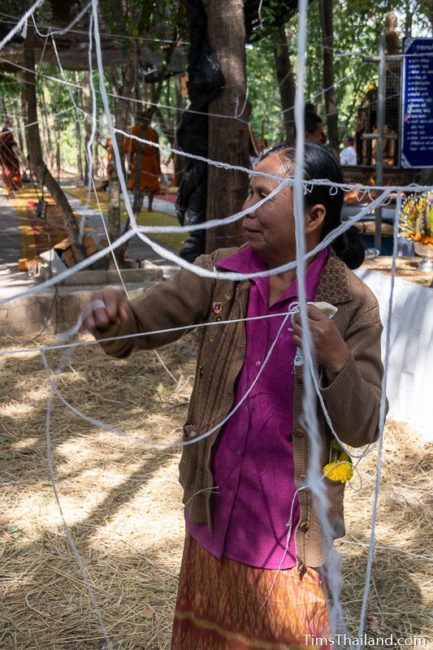 woman cutting down the string grid