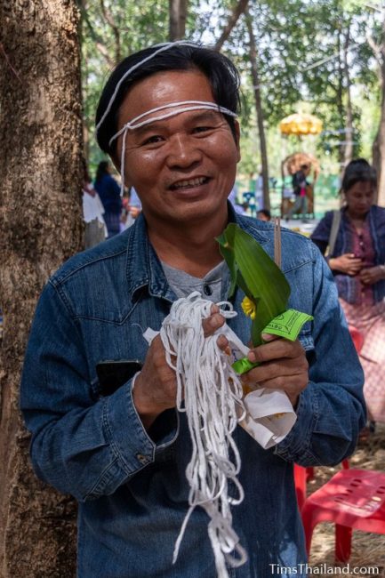 man holding white string