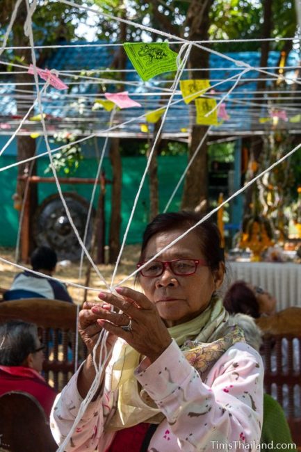 woman tying white strings