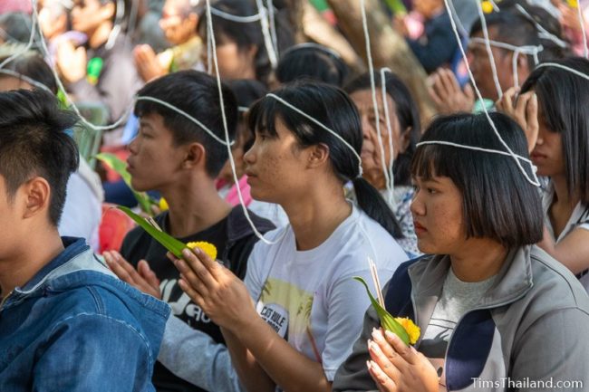 people sitting with white strings on their heads