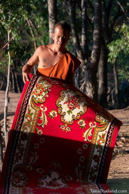 monk laying down a carpet