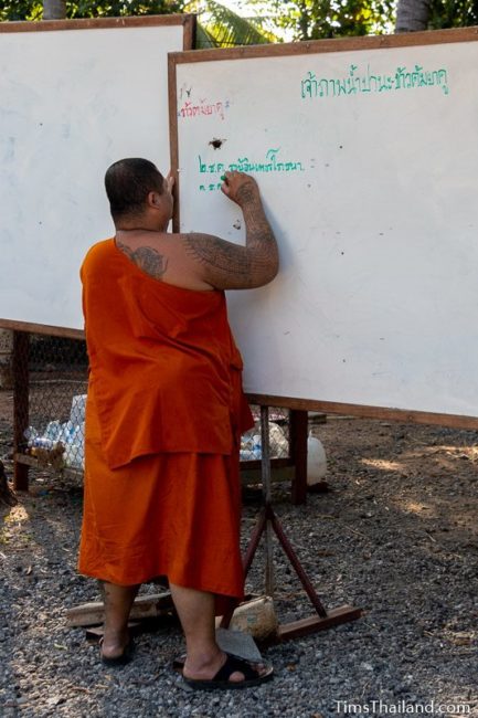 monk writing on whiteboard