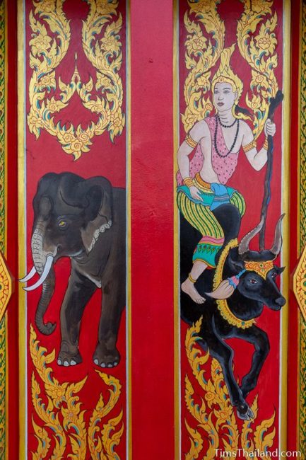 painted window shutter of elephant and a god riding a bull