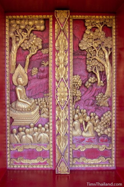 carved wood doors with Buddha giving sermon