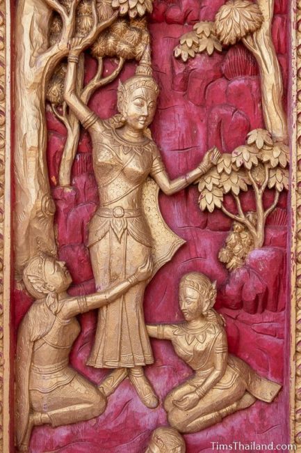 wood carving of Buddha's mother giving birth