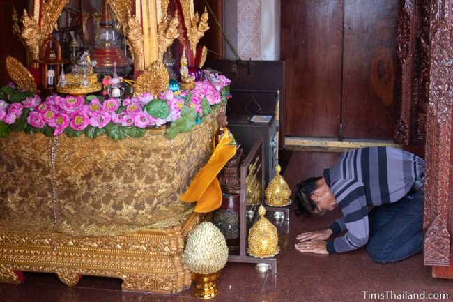 man praying in front of Buddha relic chamber