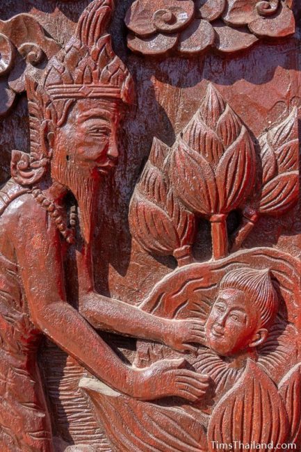 woodcarving of ruesi finding baby in lotus pond