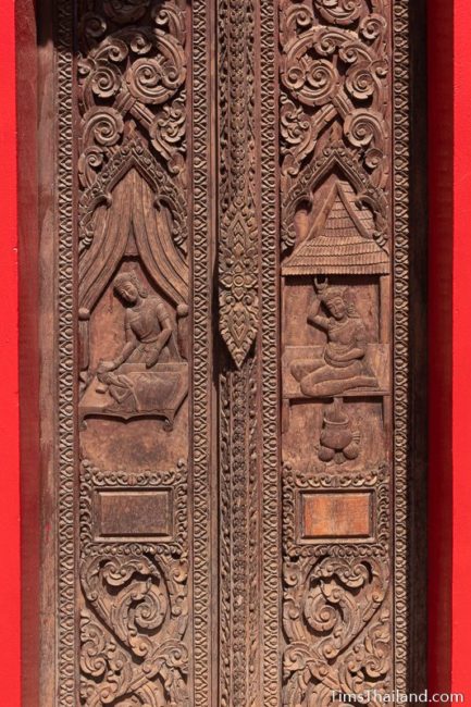 carved wood doors with birth scenes