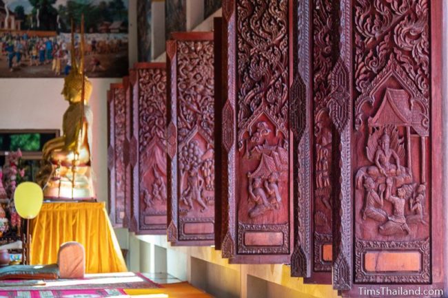 long row of carved wooden window shutters