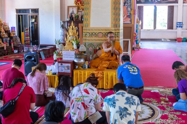 monk splashing water to bless people