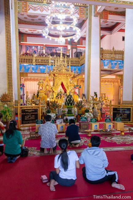 people praying in front of Buddha relic