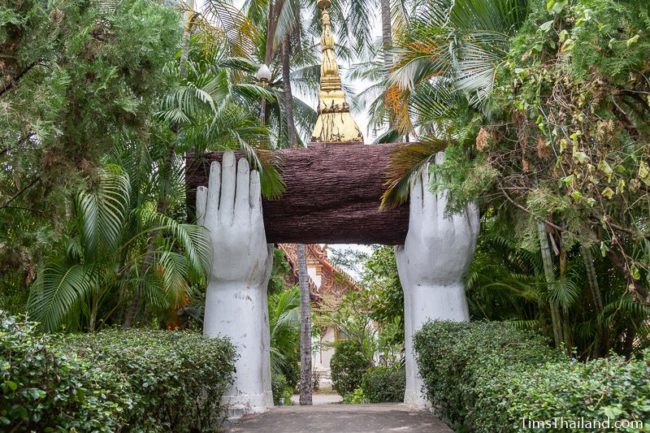 statue of hands holding a log