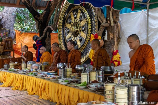 monks with food in front of them waiting to eat