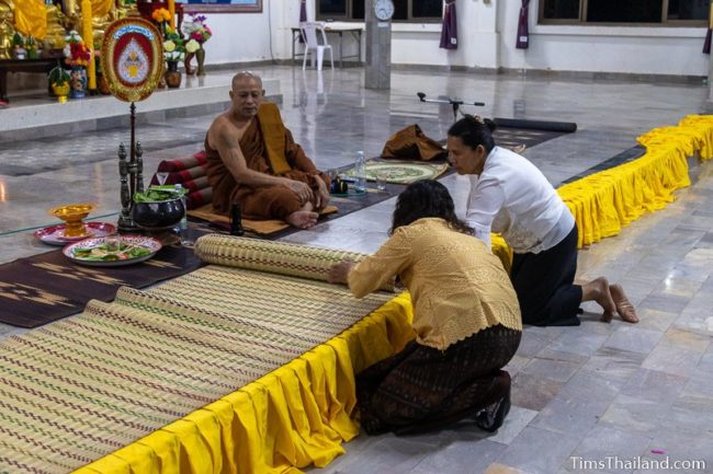 women decorating platform where monks sit