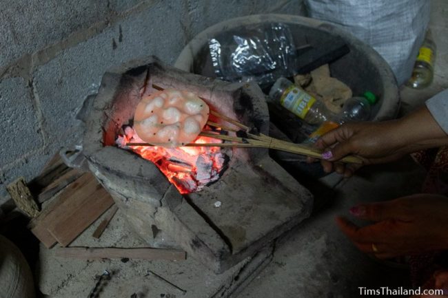 closeup of grilling khao griap in the dark of night