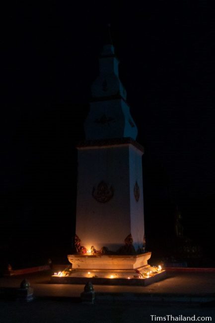 candles around the base of a stupa