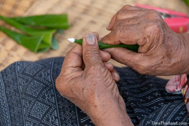 closeup of woman making bai sii