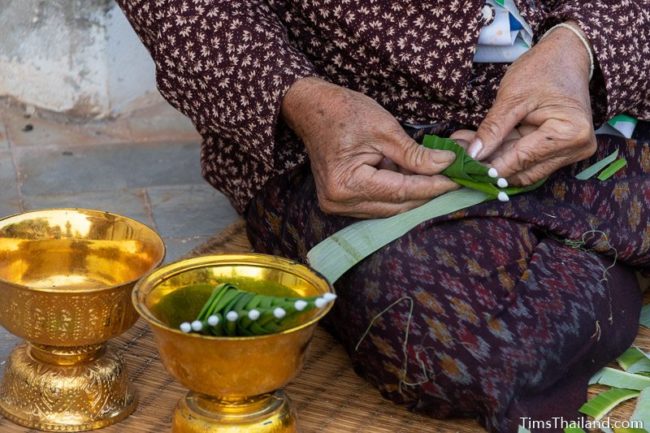 closeup of woman making bai sii