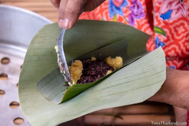 closeup of woman making khao tom mat