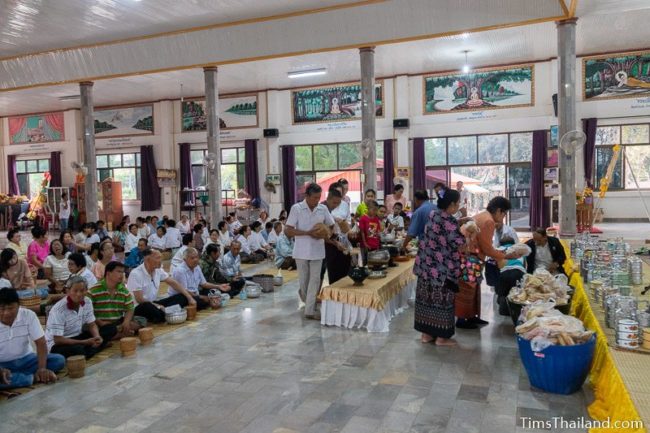 people bringing food to the temple for monks