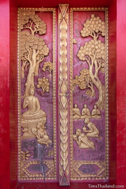 woodcarving of three women donating bowls of water to the Buddha