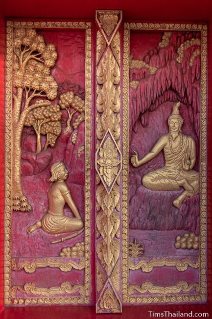 woodcarving of Angulimala sitting in front of his teacher