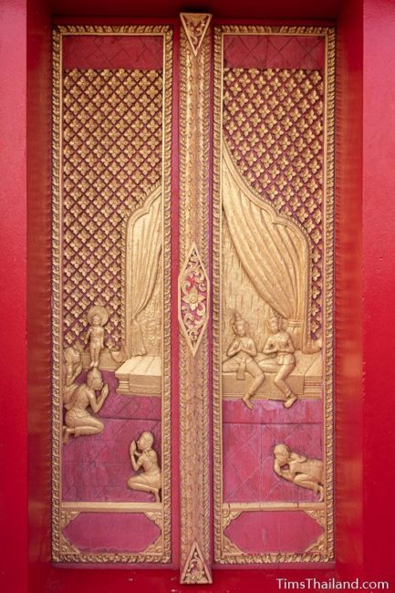 woodcarving of Asita bowing at baby Buddha's feet