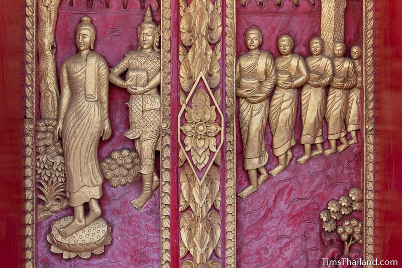 woodcarving of the Buddha walking with many disciples