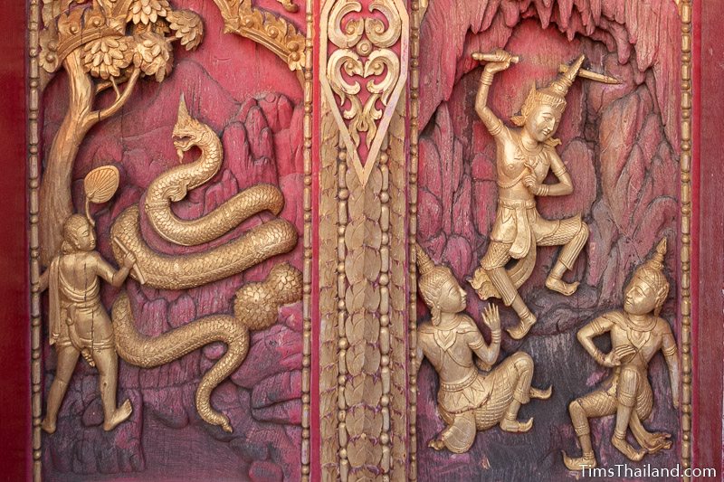 woodcarving of a giant naga and a man threatening two others with a sword