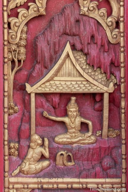 woodcarving of old man talking to rishi.