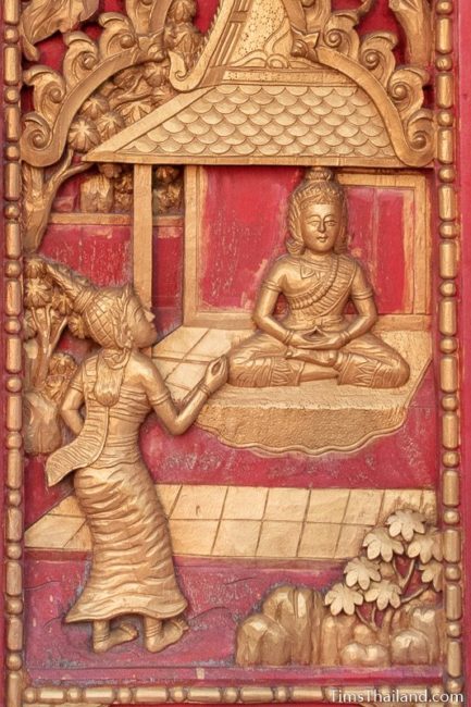 woodcarving of woman talking to man.