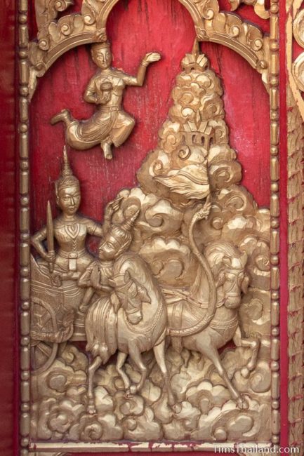 woodcarving of chariot riding through heaven.