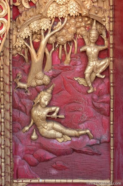 woodcarving of man lying on ground with arrow in side of his body.
