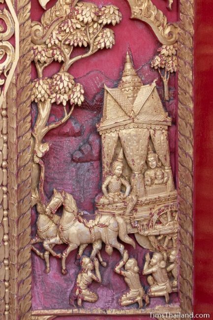 woodcarving of family riding in horse-drawn carriage.