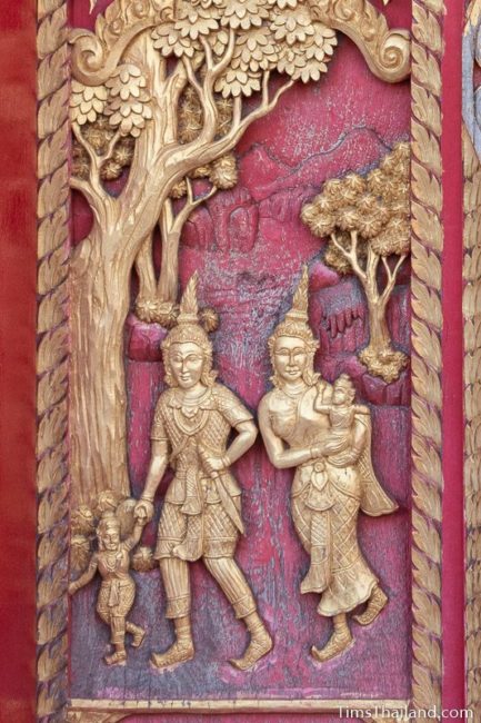 woodcarving of mother, father, and two kids walking.