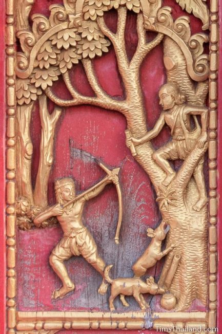 woodcarving of man shooting arrow at old man in a tree.