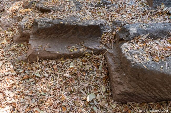 rock outcrop with blocks cut out of it