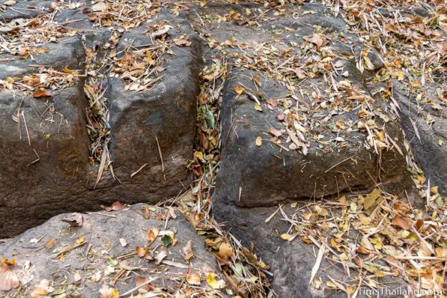 rock outcrop with blocks cut out of it