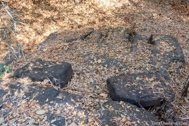 rock outcrop with blocks cut out of it