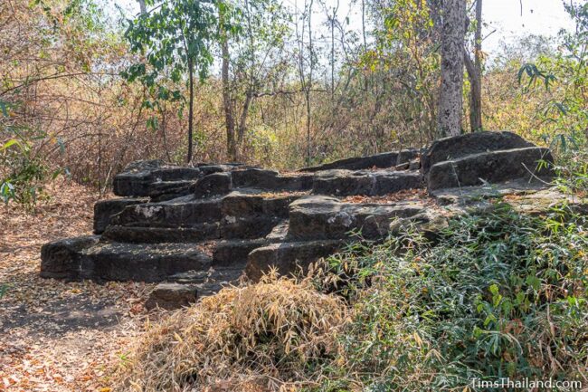 rock outcrop with blocks cut out of it