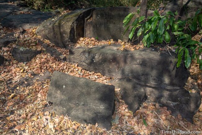 rock outcrop with blocks cut out of it