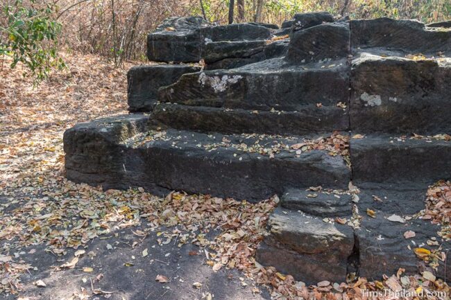 rock outcrop with blocks cut out of it