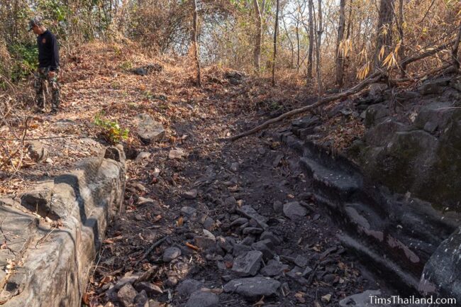 rock outcrop with blocks cut out of it