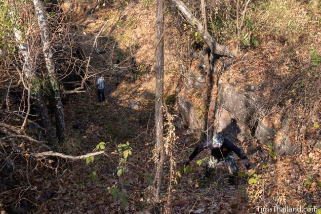 ranger climbing down into small valley